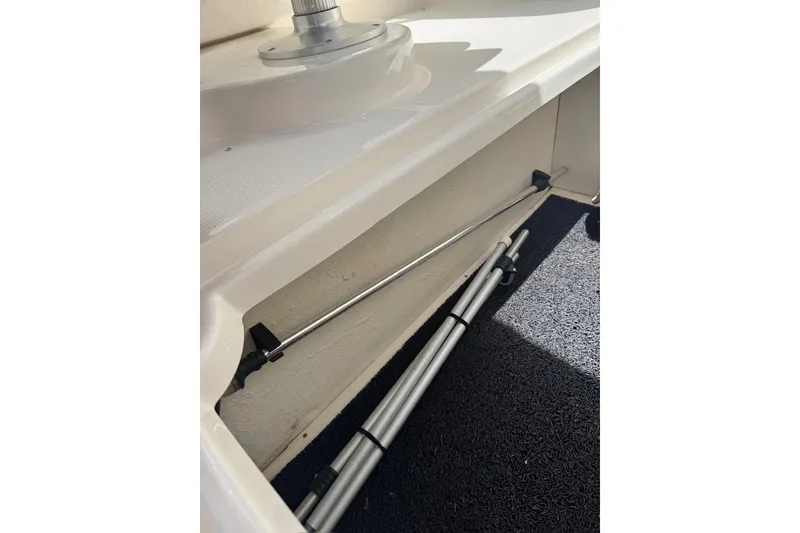 Slide: The Image of Storage compartment in a 2013 Sea Ray 280 Sundeck boat with metal rods. - 37