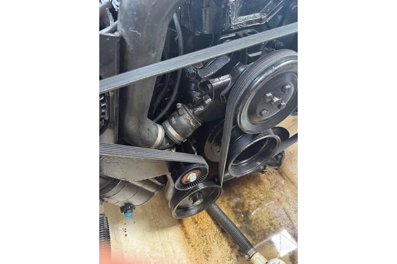 Slide: The Image of Engine components of a 2013 Sea Ray 280 Sundeck boat, featuring belts and pulleys. - 47