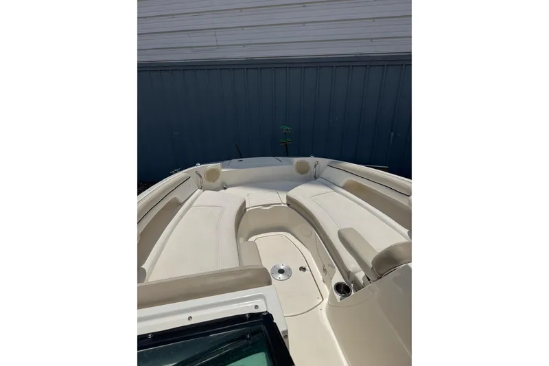 Slide: The Image of 2013 Sea Ray 280 Sundeck boat interior with beige seating and cup holders. - 5