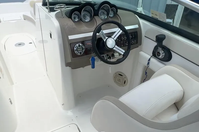 Slide: The Image of Interior view of 2013 Sea Ray 280 Sundeck boat cockpit with steering wheel and controls. - 6