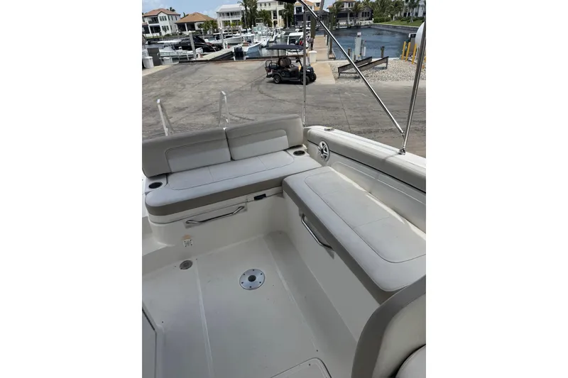 Slide: The Image of 2013 Sea Ray 280 Sundeck interior with seating, docked at marina. - 8
