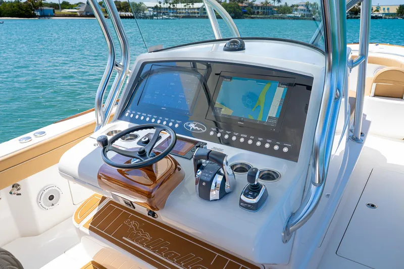 Slide: The Image of 2022 Valhalla Boatworks V-33 helm with advanced navigation system on a sunny day. - 12