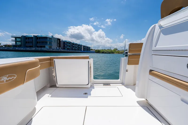Slide: The Image of 2022 Valhalla Boatworks V-33 deck view with modern seating and waterfront backdrop. - 15