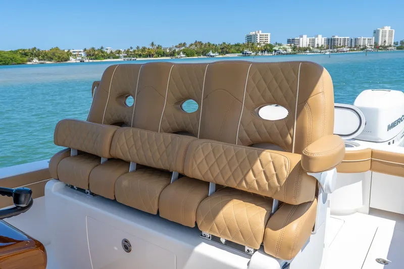 Slide: The Image of Luxurious seating on 2022 Valhalla Boatworks V-33, featuring tan quilted upholstery. - 16