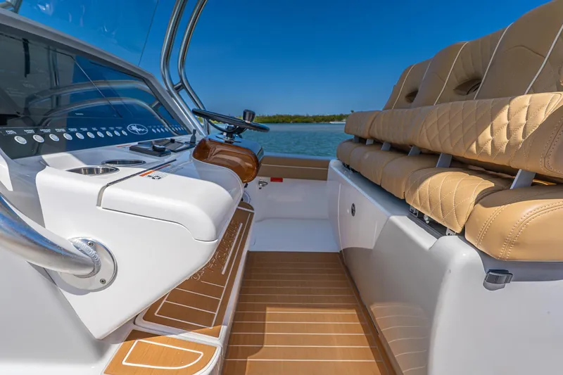 Slide: The Image of 2022 Valhalla Boatworks V-33 interior with luxurious seating and modern dashboard controls. - 17