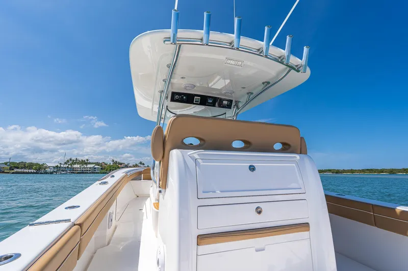 Slide: The Image of 2022 Valhalla Boatworks V-33 on water, showcasing helm and seating under clear blue sky. - 19