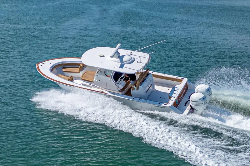 Slide: The Image of 2022 Valhalla Boatworks V-33 cruising on open water, showcasing sleek design and powerful engines. - 2