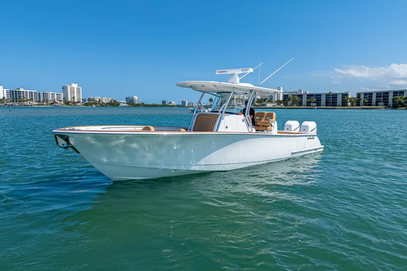 Slide: The Image of 2022 Valhalla Boatworks V-33 on water, clear sky, urban skyline in background. - 24