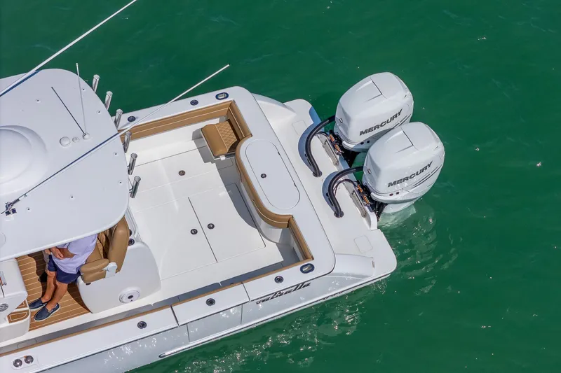 Slide: The Image of 2022 Valhalla Boatworks V-33 with dual Mercury engines on turquoise water. - 26