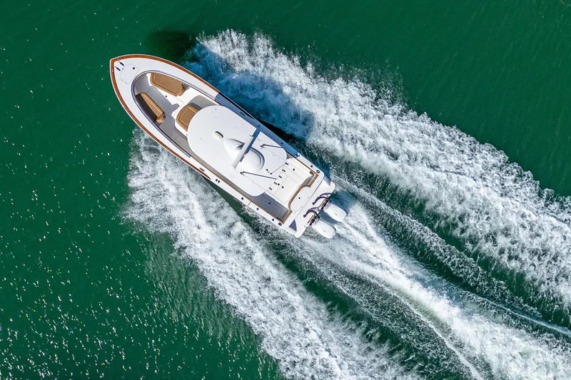 Slide: The Image of Aerial view of 2022 Valhalla Boatworks V-33 cruising on turquoise water. - 28