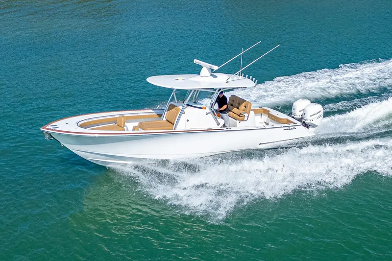Slide: The Image of 2022 Valhalla Boatworks V-33 cruising on clear blue water, showcasing sleek design and performance. - 3