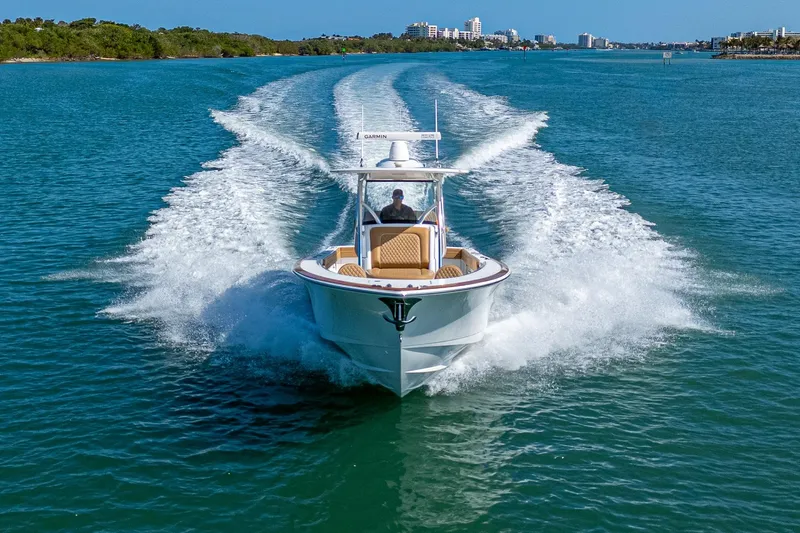 Slide: The Image of 2022 Valhalla Boatworks V-33 cruising on clear blue water, leaving a wake trail. - 31