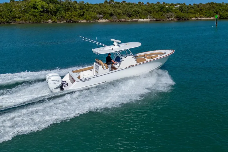 Slide: The Image of 2022 Valhalla Boatworks V-33 cruising on clear blue water, showcasing sleek design and performance. - 33