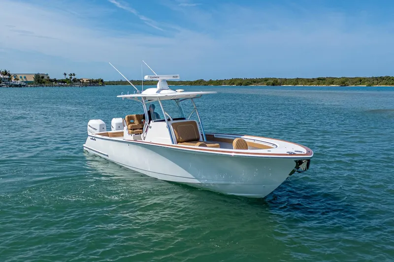 Slide: The Image of 2022 Valhalla Boatworks V-33 cruising on clear blue water under a sunny sky. - 4