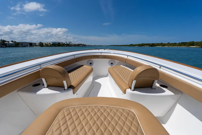 Slide: The Image of 2022 Valhalla Boatworks V-33 interior with tan seating, cruising on a sunny day. - 5
