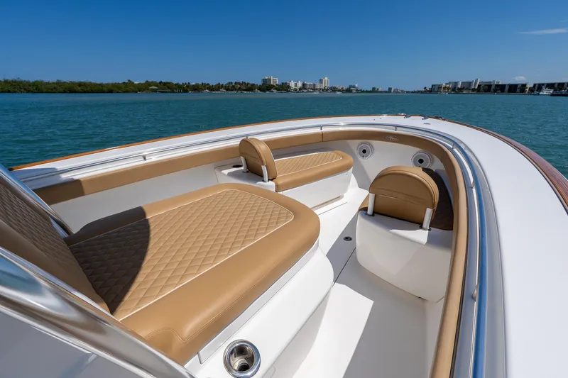 Slide: The Image of 2022 Valhalla Boatworks V-33 with tan seating, cruising on a sunny day. - 6