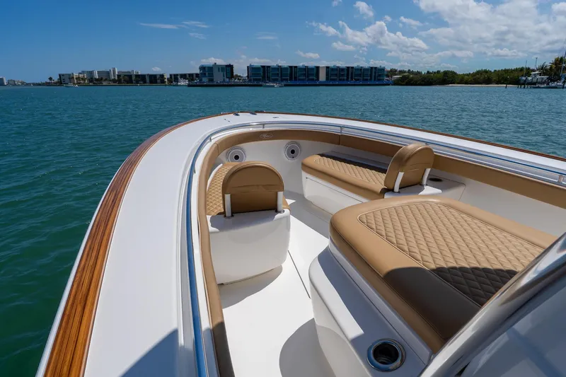 Slide: The Image of 2022 Valhalla Boatworks V-33 interior with tan seating, cruising on a sunny day. - 7