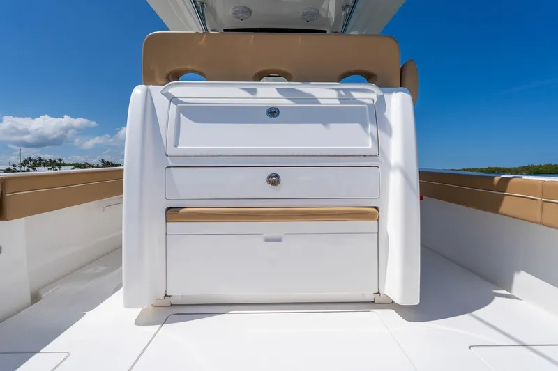 Slide: The Image of 2022 Valhalla Boatworks V-33 interior with storage compartments under clear blue sky. - 9