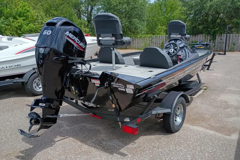 Slide: The Image of 2022 Tracker Pro Team 175 TXW boat with Mercury 60 engine, parked outdoors. - 44