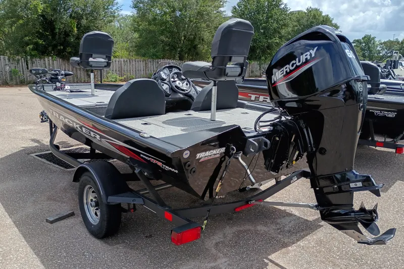 Slide: The Image of 2022 Tracker Pro Team 175 TXW boat with Mercury engine, parked outdoors. - 45