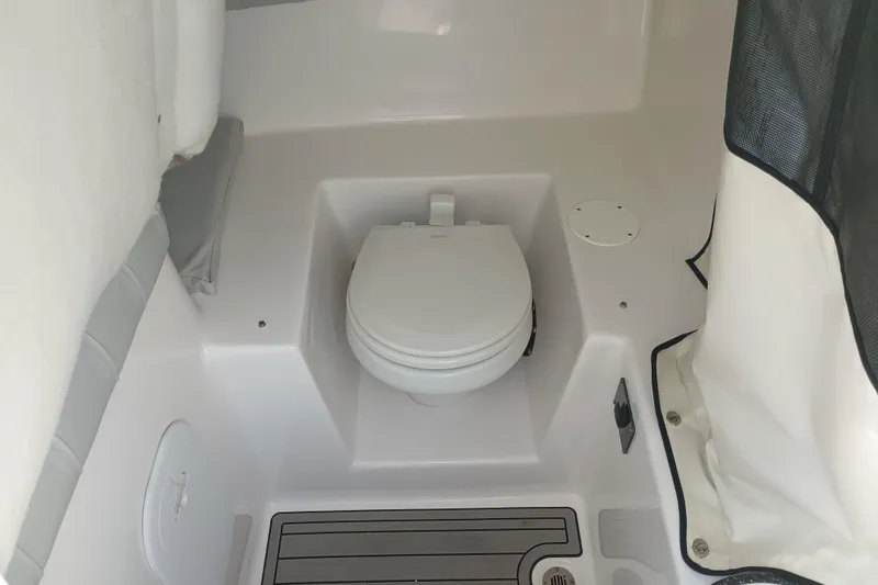 Slide: The Image of Interior of 2020 Sea Fox 249 Avenger boat featuring a compact marine toilet. - 15