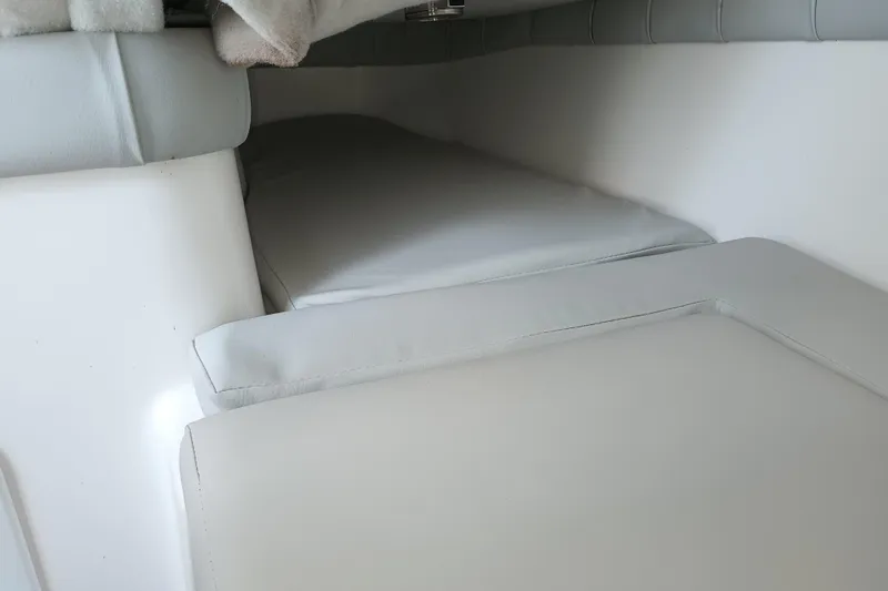 Slide: The Image of 2020 Sea Fox 249 Avenger cabin interior with cushioned seating and sleeping area. - 16