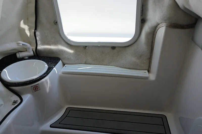 Slide: The Image of Interior view of 2020 Sea Fox 249 Avenger boat, featuring a compact sink and window. - 17