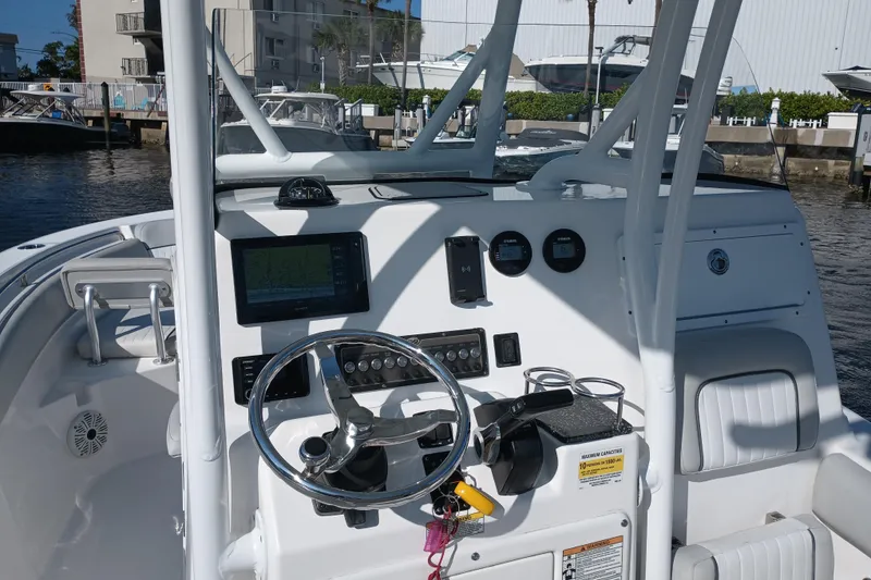 Slide: The Image of 2020 Sea Fox 249 Avenger boat dashboard with steering wheel and navigation equipment. - 18