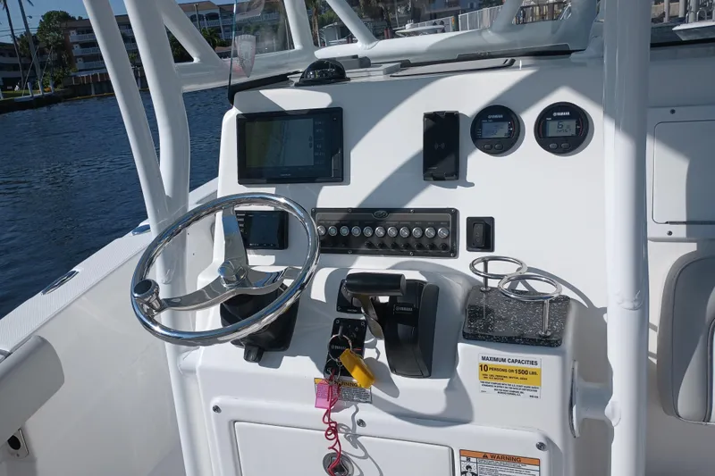 Slide: The Image of 2020 Sea Fox 249 Avenger boat dashboard with steering wheel and navigation controls. - 19