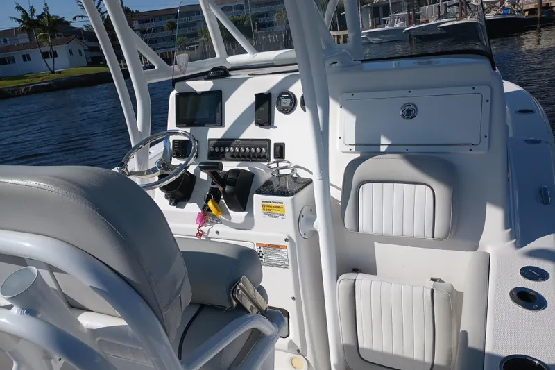 Slide: The Image of 2020 Sea Fox 249 Avenger boat cockpit with steering wheel and control panel. - 20