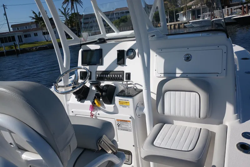 Slide: The Image of 2020 Sea Fox 249 Avenger boat cockpit with steering wheel and navigation equipment. - 21