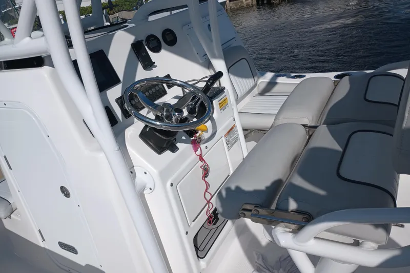 Slide: The Image of 2020 Sea Fox 249 Avenger boat interior with steering wheel and seating. - 23