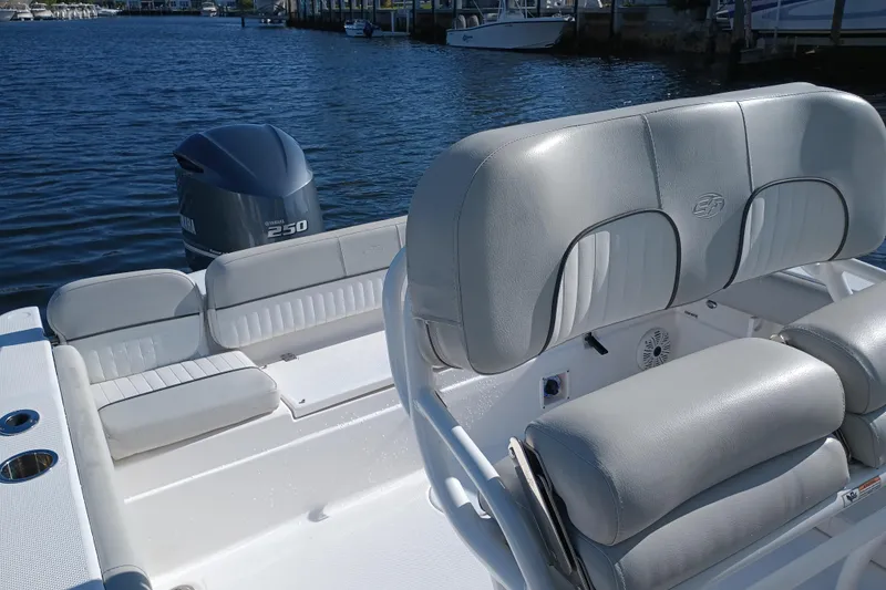 Slide: The Image of 2020 Sea Fox 249 Avenger boat interior with Yamaha 250 engine, docked by the water. - 27