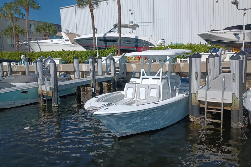 Slide: The Image of 2020 Sea Fox 249 Avenger boat docked at marina with palm trees and other boats. - 3