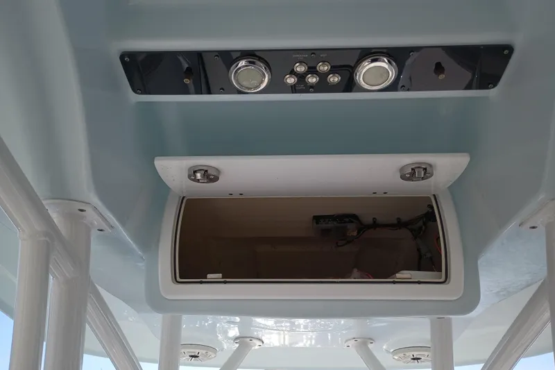 Slide: The Image of 2020 Sea Fox 249 Avenger boat console with open storage compartment and control panel. - 34