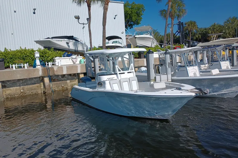 Slide: The Image of 2020 Sea Fox 249 Avenger boat docked at marina with palm trees and clear sky. - 38