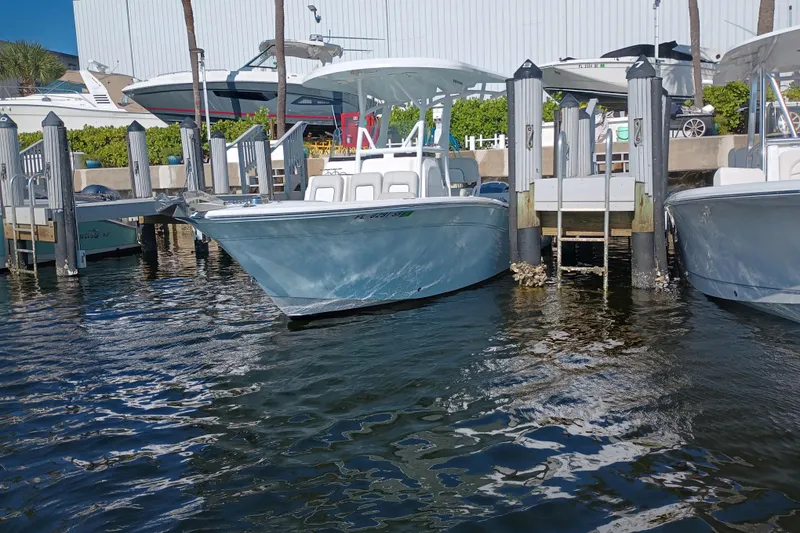 Slide: The Image of 2020 Sea Fox 249 Avenger boat docked at marina, surrounded by water and other vessels. - 39