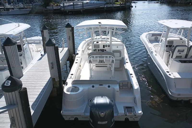 Slide: The Image of 2020 Sea Fox 249 Avenger boat docked, featuring sleek design and spacious deck. - 4