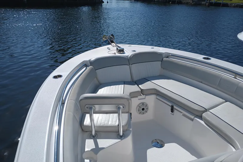 Slide: The Image of 2020 Sea Fox 249 Avenger boat interior with cushioned seating on calm water. - 5