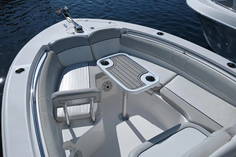 Slide: The Image of 2020 Sea Fox 249 Avenger boat interior with seating and table on calm water. - 6