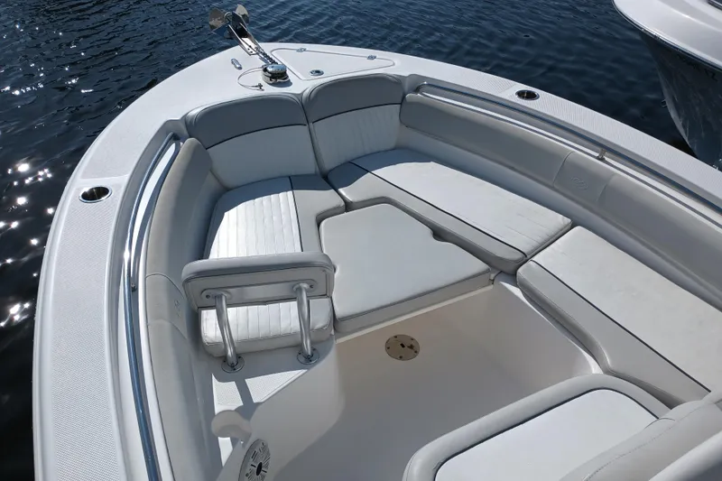 Slide: The Image of 2020 Sea Fox 249 Avenger boat interior with cushioned seating on calm water. - 7