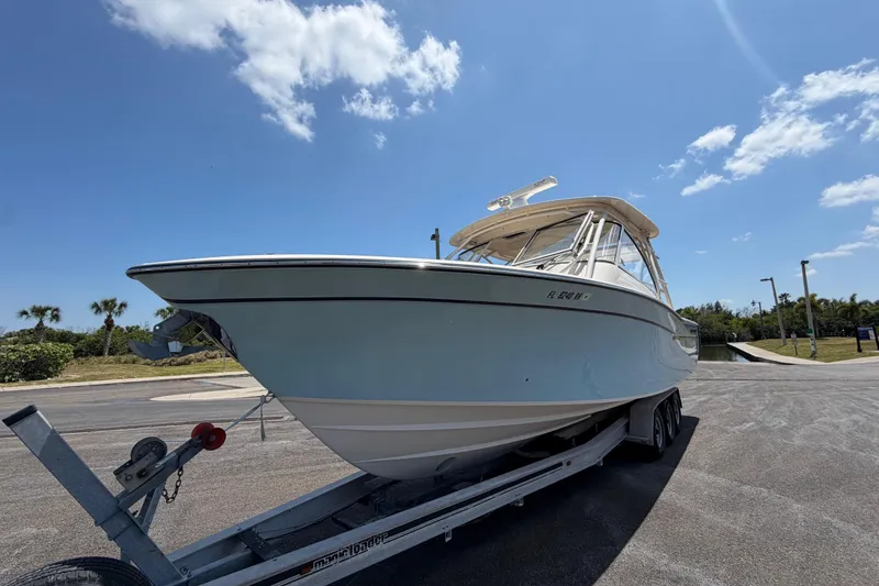 Slide: The Image of 2018 Grady-White Freedom 335 boat on trailer under clear blue sky. - 11