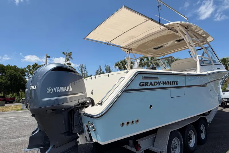 Slide: The Image of 2018 Grady-White Freedom 335 boat with Yamaha engine, parked outdoors under clear sky. - 12