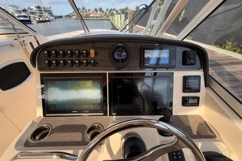 Slide: The Image of 2018 Grady-White Freedom 335 boat cockpit with dual Garmin displays and plush seating. - 16