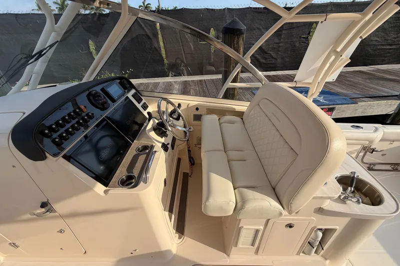 Slide: The Image of 2018 Grady-White Freedom 335 boat interior with helm and seating area. - 17