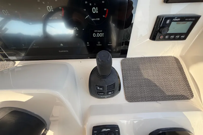 Slide: The Image of Luxurious seating on 2018 Grady-White Freedom 335 boat, docked by the water. - 19