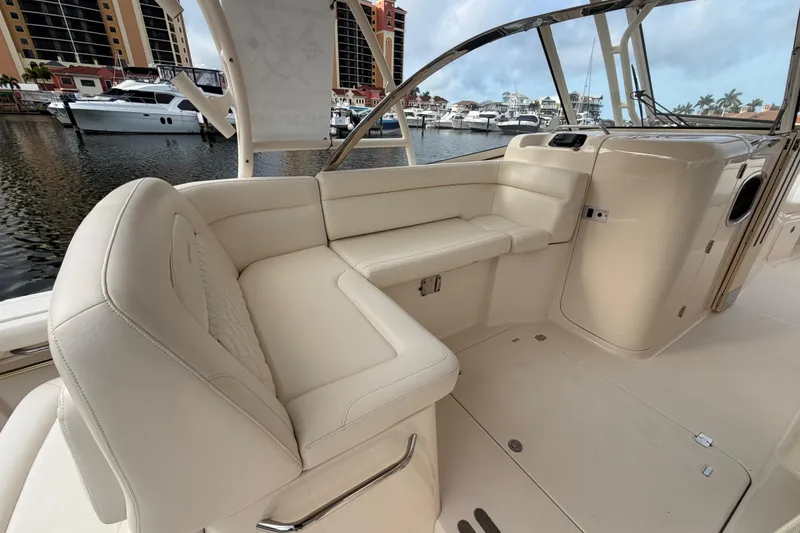 Slide: The Image of 2018 Grady-White Freedom 335 boat interior, featuring spacious seating and modern amenities at a marina. - 22