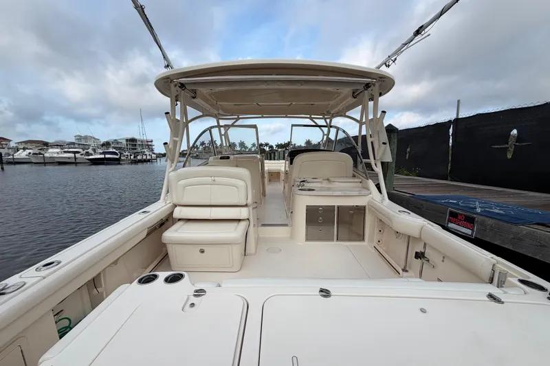 Slide: The Image of 2018 Grady-White Freedom 335 boat interior with luxurious seating at a marina. - 24
