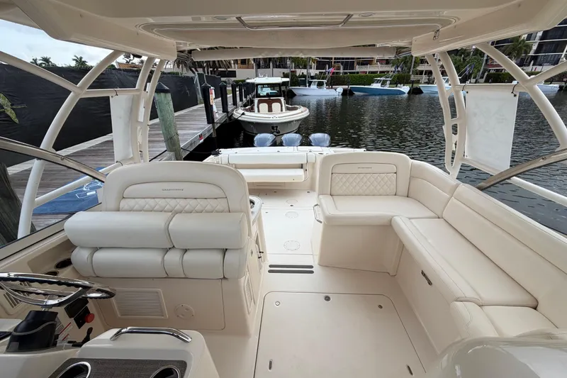 Slide: The Image of 2018 Grady-White Freedom 335 boat with dual engines docked at marina. - 25