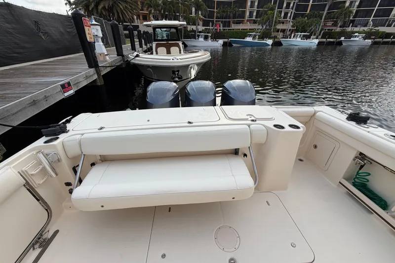 Slide: The Image of 2018 Grady-White Freedom 335 boat interior with seating and helm, docked at marina. - 26